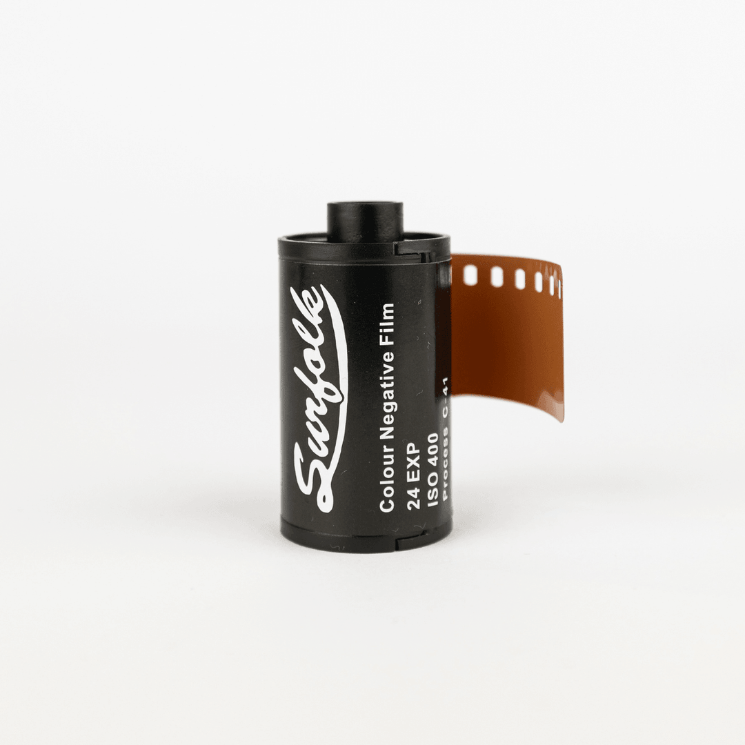 A roll of Surfolk 35mm film with part of the film strip visible, predominantly black and white in color with the brand name and details visible on the roll.