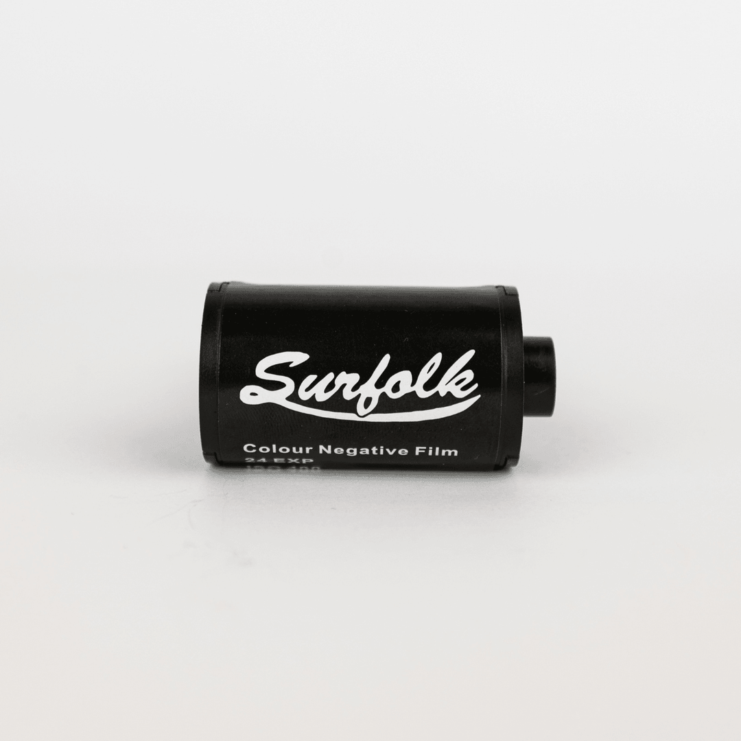 Black film canister with 'Surfolk' branding on a white background
