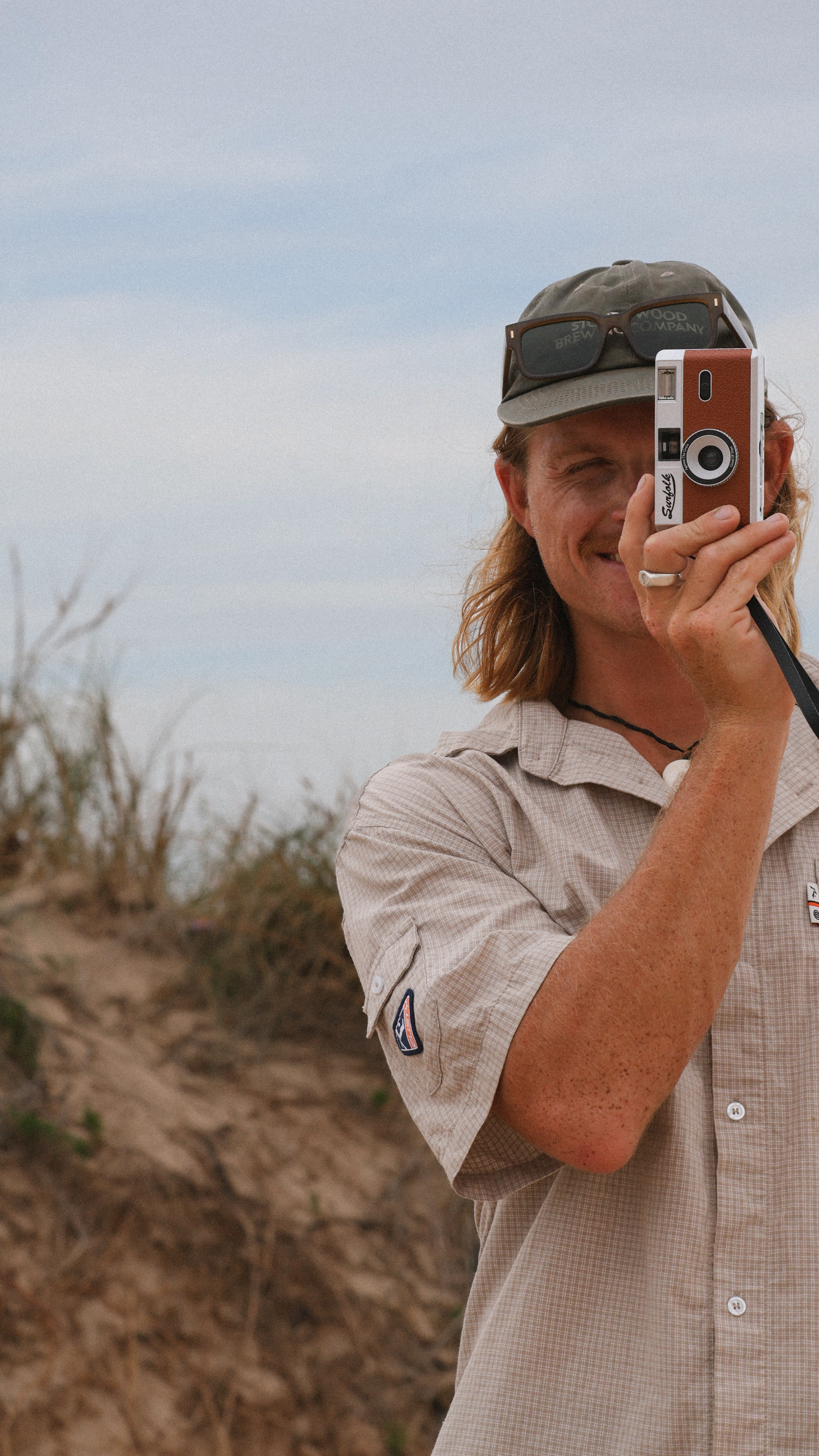 Man taking a photo with an old-fashioned camera outdoors